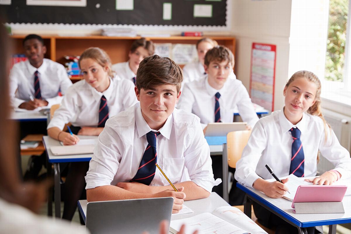 Group of students sitting in classroom looking at teacher